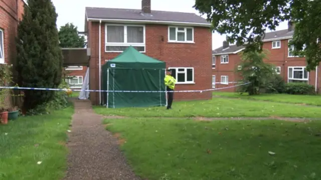 Police tape and forensic tent at the property