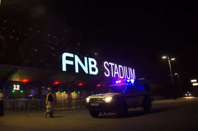 Emergency service marshals and vehicles leave from the FNB stadium where two people died during a stampede which occurred at one of the entrances to the stadium on July 29, 2017 in Johannesburg.