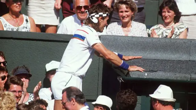 Pat Cash of Australia in climbs into the crowd after winning the Men's singles final against Ivan Lendl at the All Lawn Tennis Championships held in Wimbledon,London in July 1987.