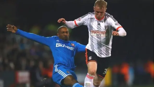 Jack Grimmer playing for Fulham against Jermaine Defoe