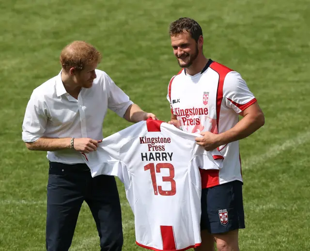 Prince Harry receives an England shirt from England Rugby League captain Sean O"Loughlin