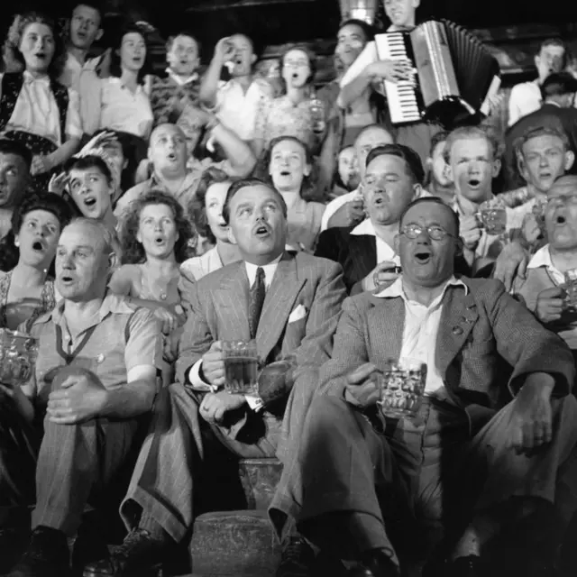 British holiday camp promoter Billy Butlin (centre) joins in with a sing along at one of his holiday camps in Clacton