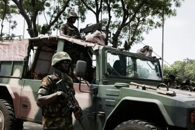 Soldiers take part in a military procession for Major Maxwell Adam Mahama's state funeral on June 9, 2017 in Accra