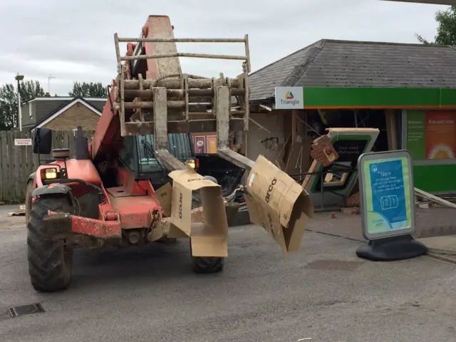 Fork-lift vehicle and damage done to petrol garage