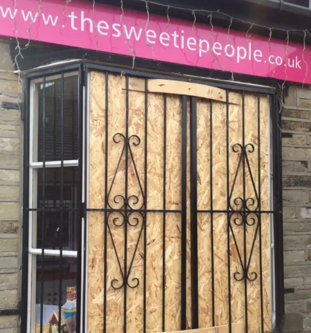 Broken window at sweet shop in Wyke