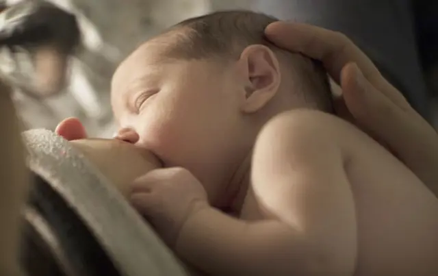 Baby being breastfed