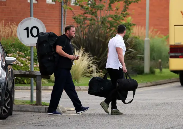 Prison officers carrying bags