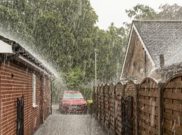 Hail hammering down onto a roof and path