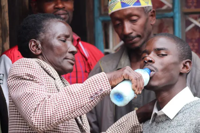 Woman giving a man a drink