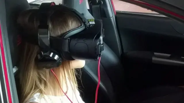 Young woman watches via VR headset