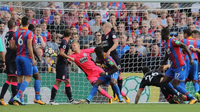 Jonas Lossl saves Christian Benteke's header at the goal