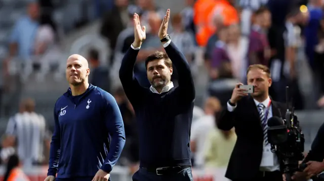 Mauricio Pochettino applauds the fans