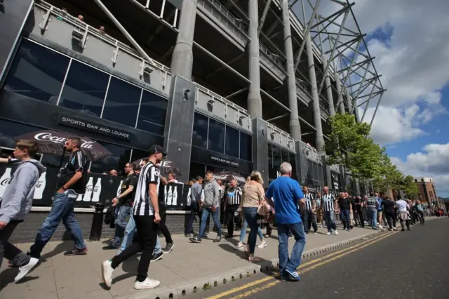 Fans arrive at the stadium