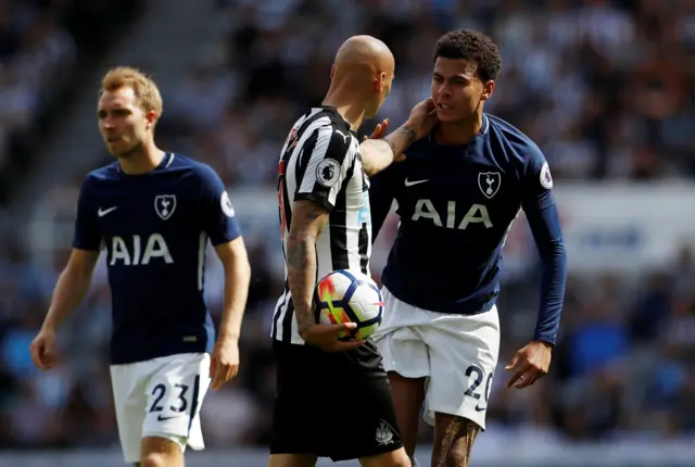 Jonjo Shelvey reacts after stamping on Dele Alli