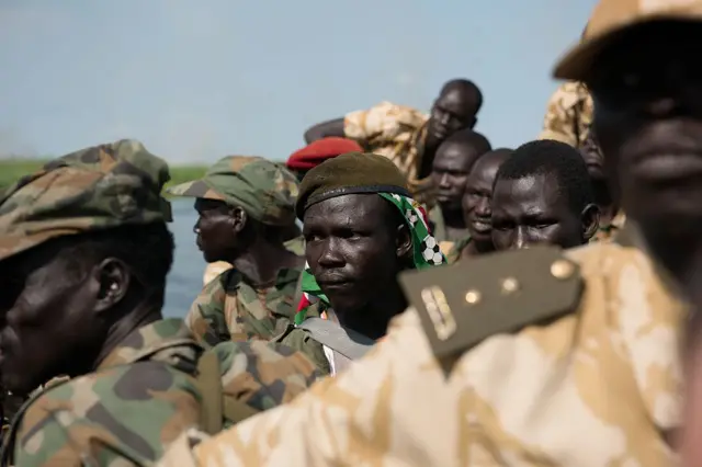 Sudan People Liberation Army (SPLA) soldiers ride on a boat on the Nile river