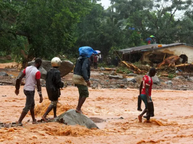 People walking through floods