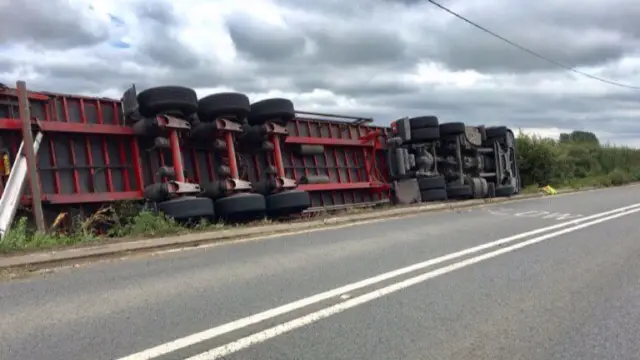 Overturned lorry on A543