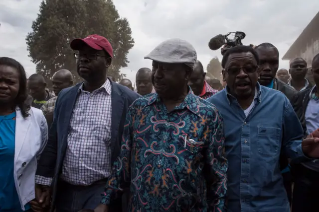 Opposition candidate Raila Odinga walks to address his supporters in the Kibera slum on August 13, 2017 in Nairobi, Kenya