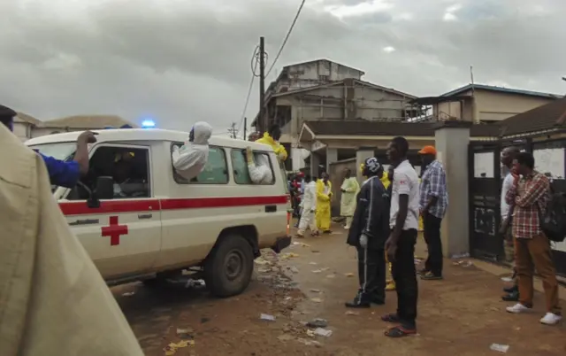 Emergency services work at the scene of a mudslide in the suburb of Regent behind Guma reservoir, Freetown, Sierra Leone, 14 August 2017.