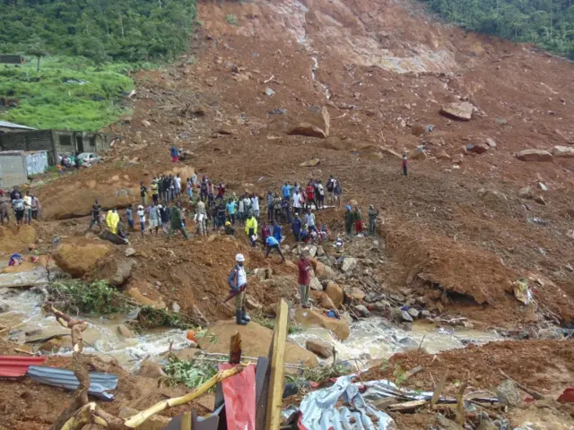 Residents view damage caused by a mudslide in the suburb of Regent behind Guma reservoir, Freetown, Sierra Leone, 14 August 2017.