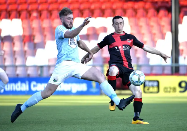 Crusaders Paul Heatley in action with Warrenpoint Town's Jordan Lyttle