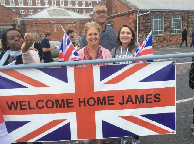 Proud mother and father Jane and Richard Lloyd wait with their son's girlfriend Claire Harris