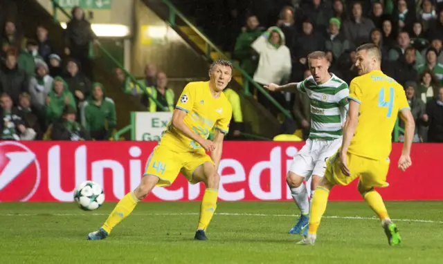 Leigh Griffiths looks on as his shot is deflected off Igor Shitov into the Astana net