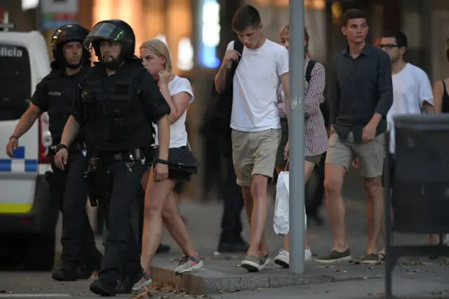 Police accompany people at the scene