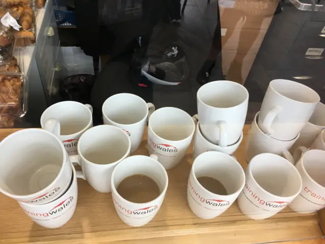 Empty coffee cups on a desk