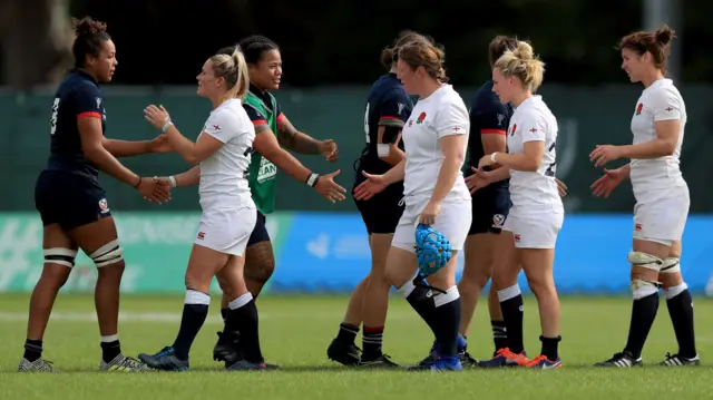 Players shake hands at the end of the game