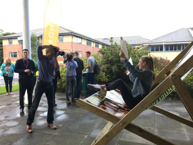 A student poses on a giant deckchair at Neath Port Talbot College