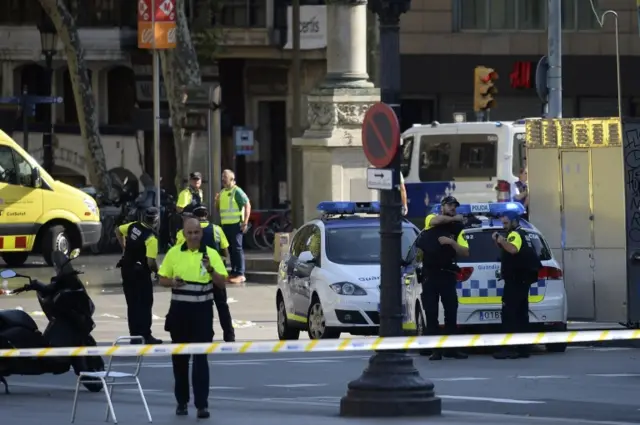 Police suit up behind a cordoned area