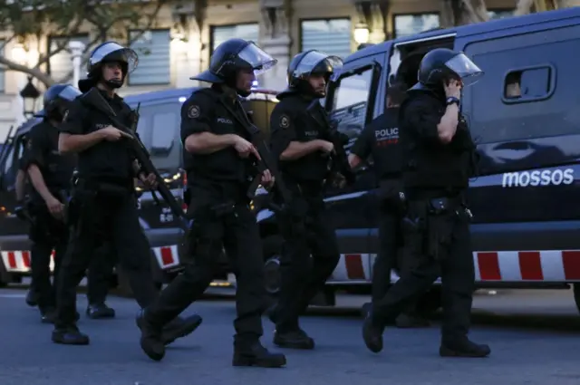 Armed police roam the streets in high security uniforms and helmets