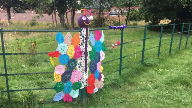 Knitted butterfly on fence at edge of St George's Hospital