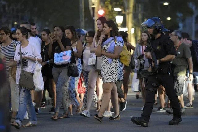 Police accompany people close to the scene