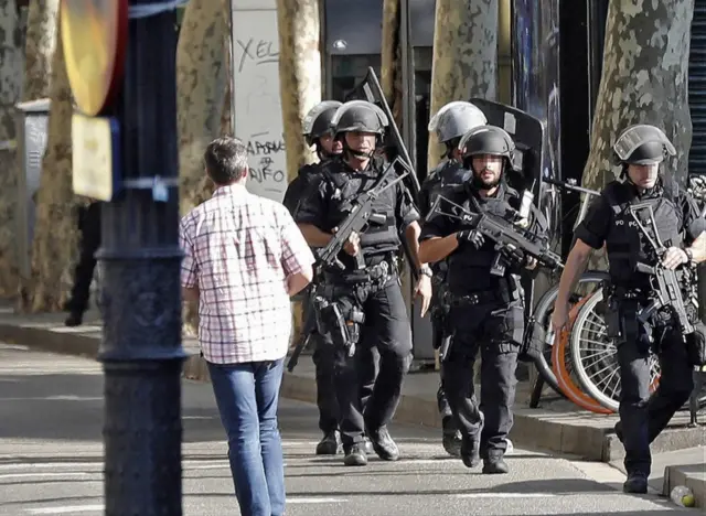 Heavily armed officers move down Las Ramblas