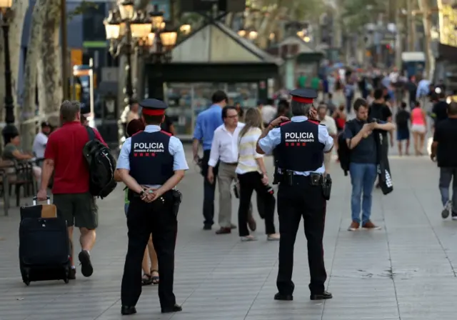 Catalan Mossos d"esquadra officers patrol at Las Ramblas