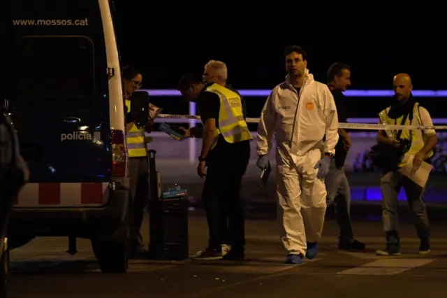 Policemen check the area after police killed five attackers in Cambrils near Tarragona