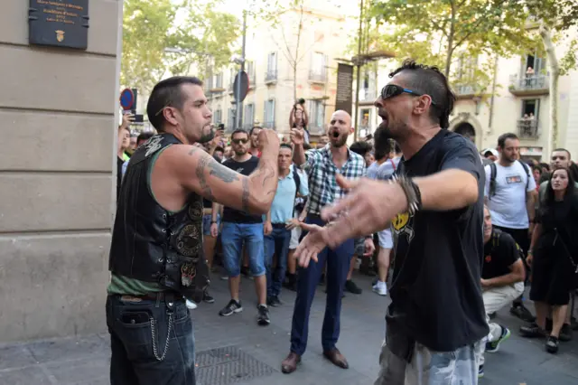 An anti-fascist protester (R) confronts a Falangist