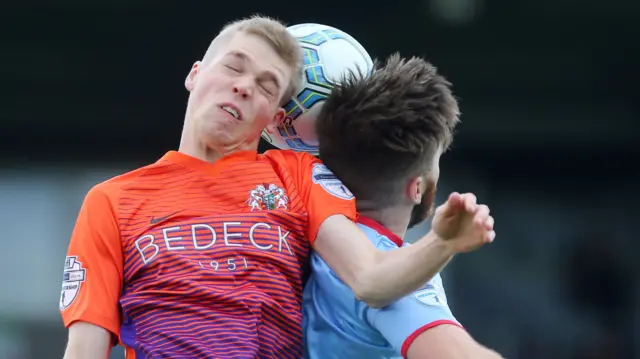 Glenavon's Rhys Marshall in action against Ballymena's Cathair Friel.