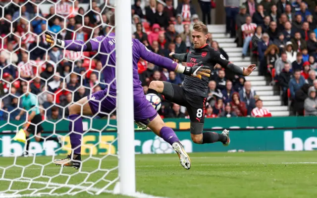 Aaron Ramsey is met by an approaching Jack Butland