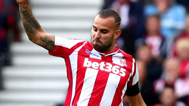 Jese of Stoke City tackles Shkodran Mustafi of Arsenal