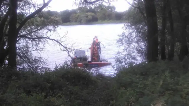 Digger in the lake at nature reserve