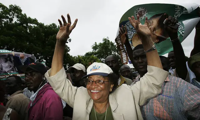 Liberian presidential candidate Ellen Johnson Sirleaf wades through supporters at a campaign rally October 4, 2005