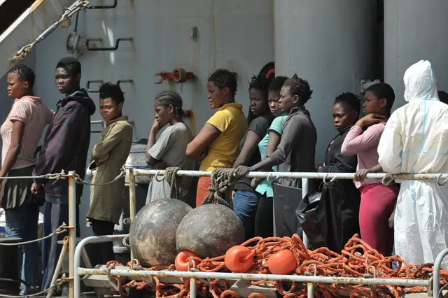 Women rescued at sea arrive aboard the Italian Navy ship Vega