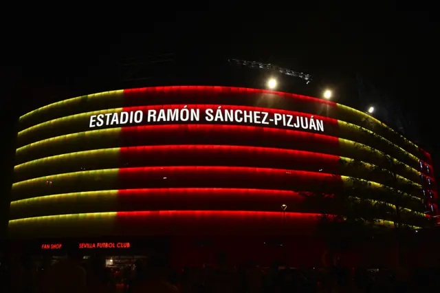 Sevilla's stadium lit up with the colours of the flag of Catalonia