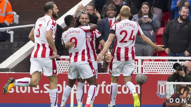 Stoke City's Spanish striker Jese (C) celebrates with teammates after scoring against Arsenal