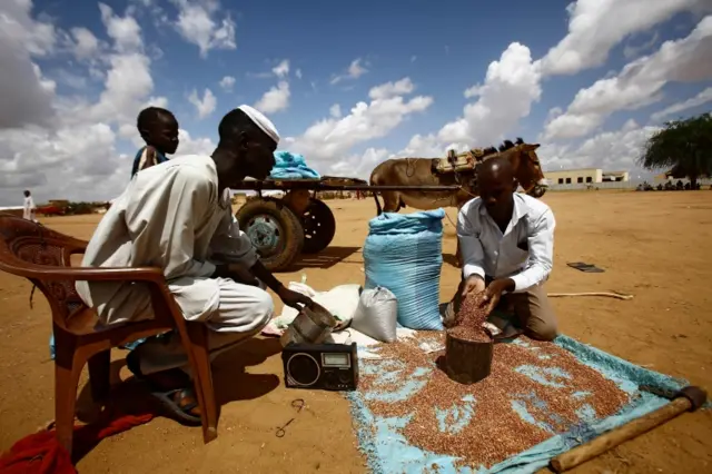 A vendor sells beans at the Al-Nimir camp for South Sudanese refugees in the Sudanese state of East Darfur on August 15, 2017