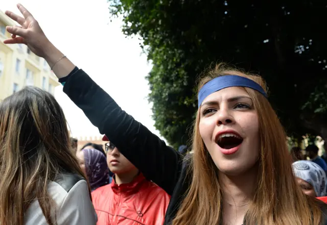 A Moroccan woman flashes the sign for victory during a protest calling for gender equality marking International women's day in Rabat on March 8, 2015