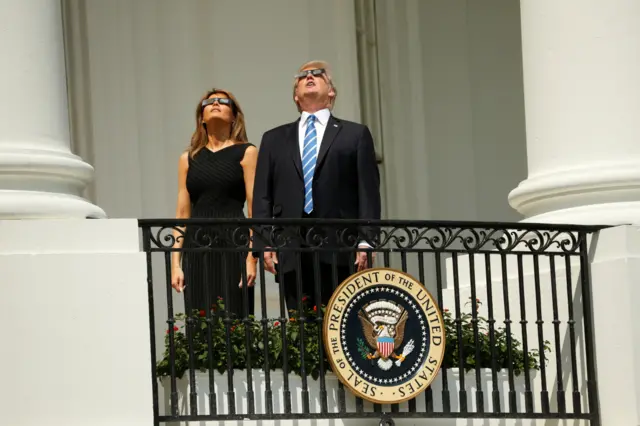 Mr and Mrs Trump watch the total eclipse from the White House